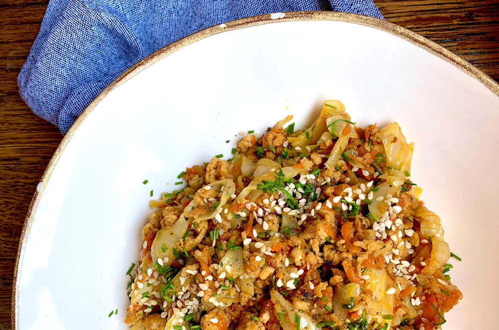 Chef Megan Mitchell’s egg roll dish served in a white ceramic bowl with a gold rim.